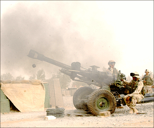 firing M119 howitzer