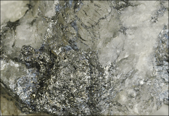 Meneghinite  crystalline crust on Quartz