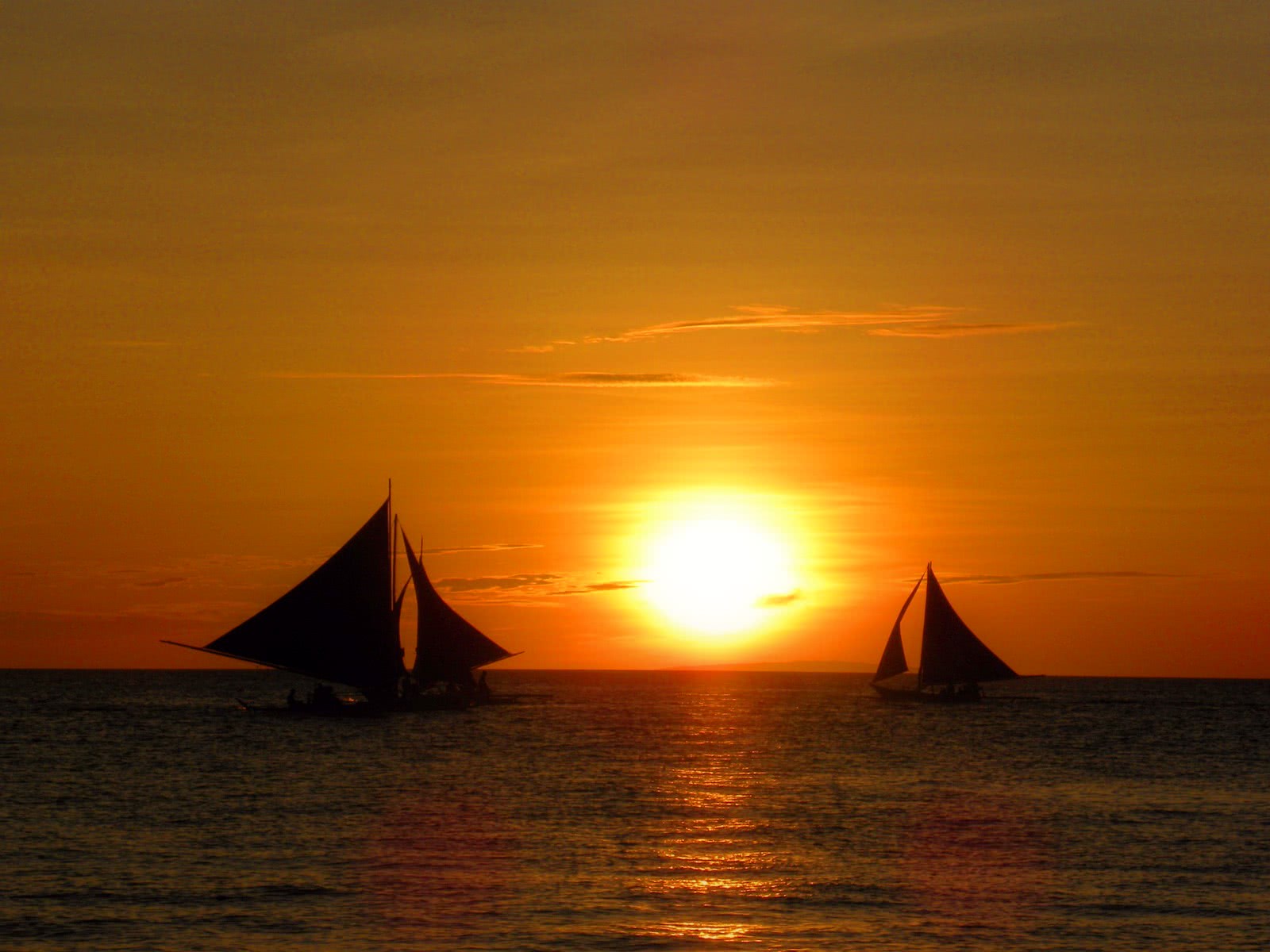 sunset sailboats