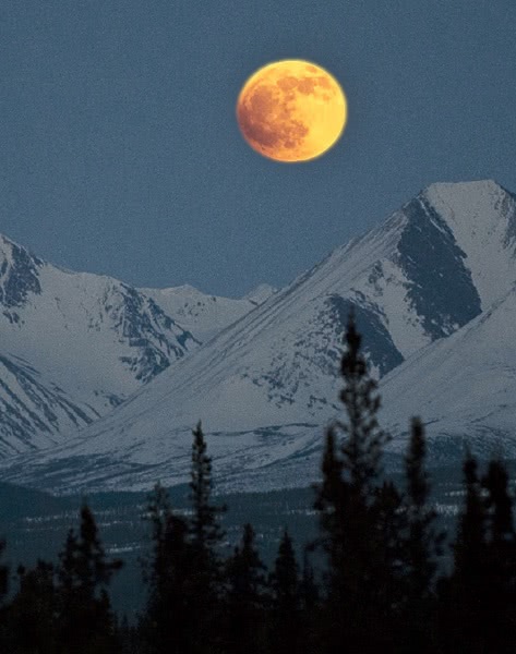 blood moon over mountains
